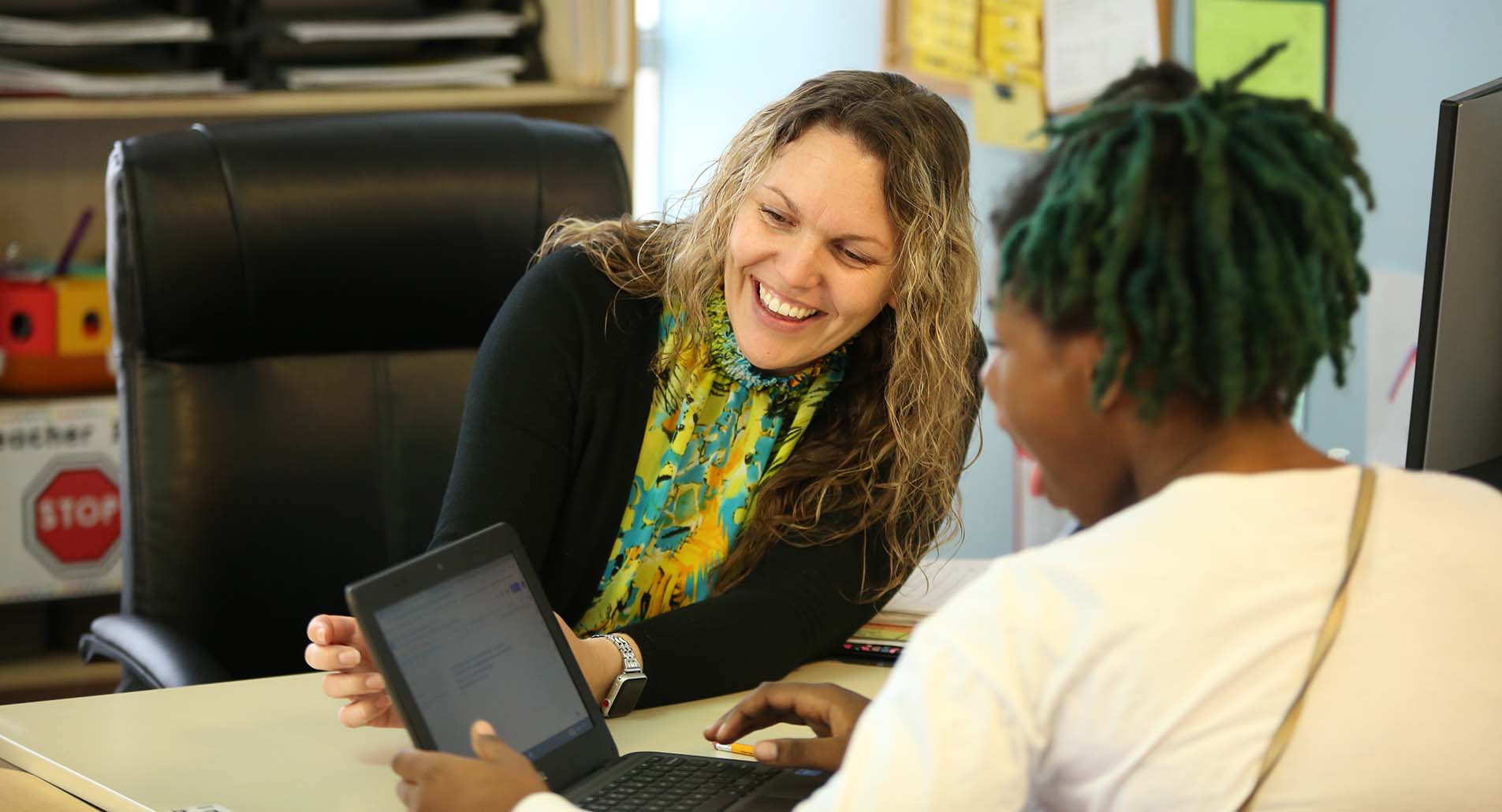 Teacher helping student