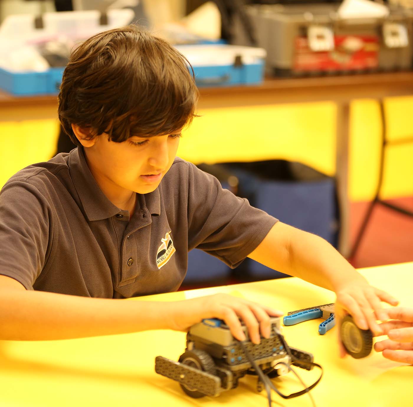 Noble Academy Columbus student drawing at a desk in a classroom setting