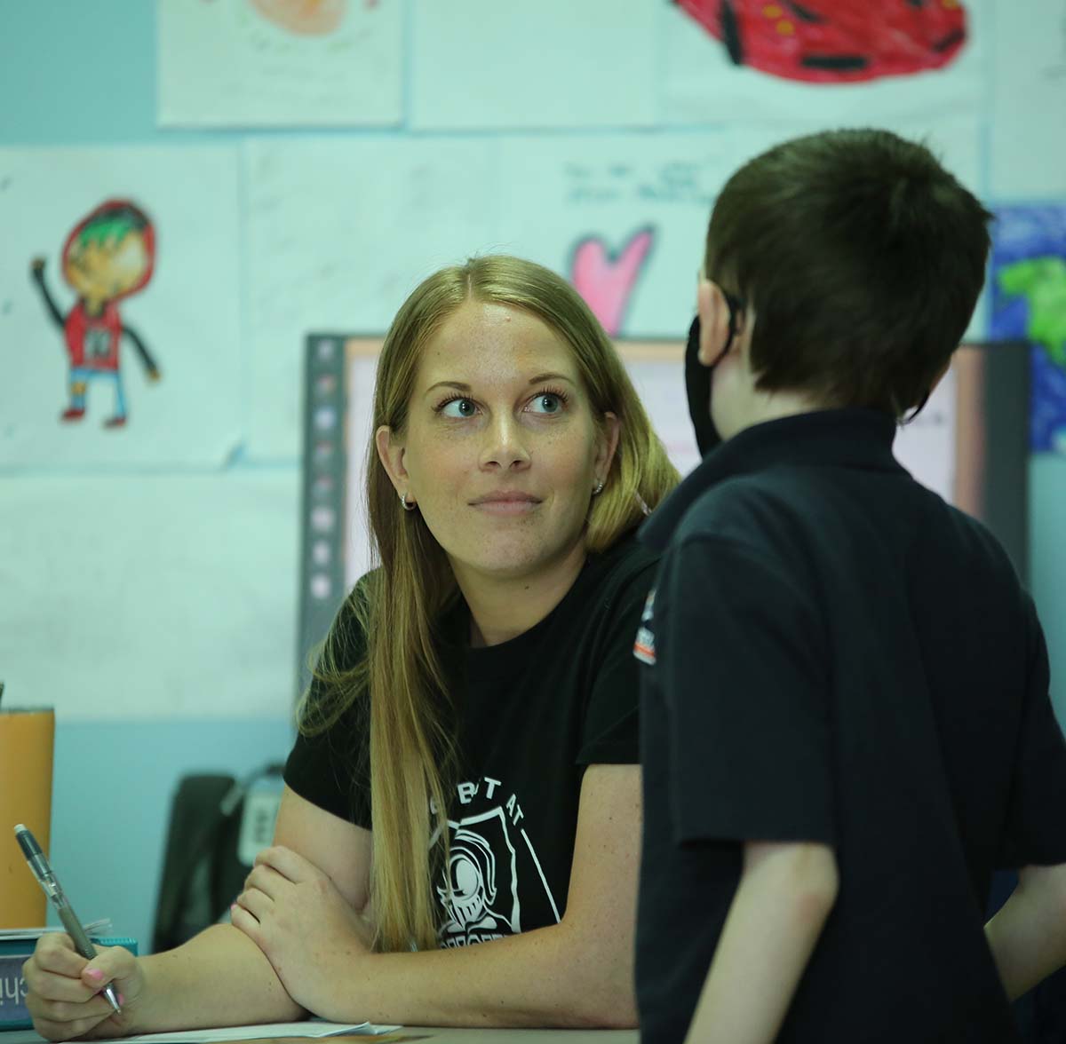 Noble Academy Columbus Teacher and student interacting at a classroom desk